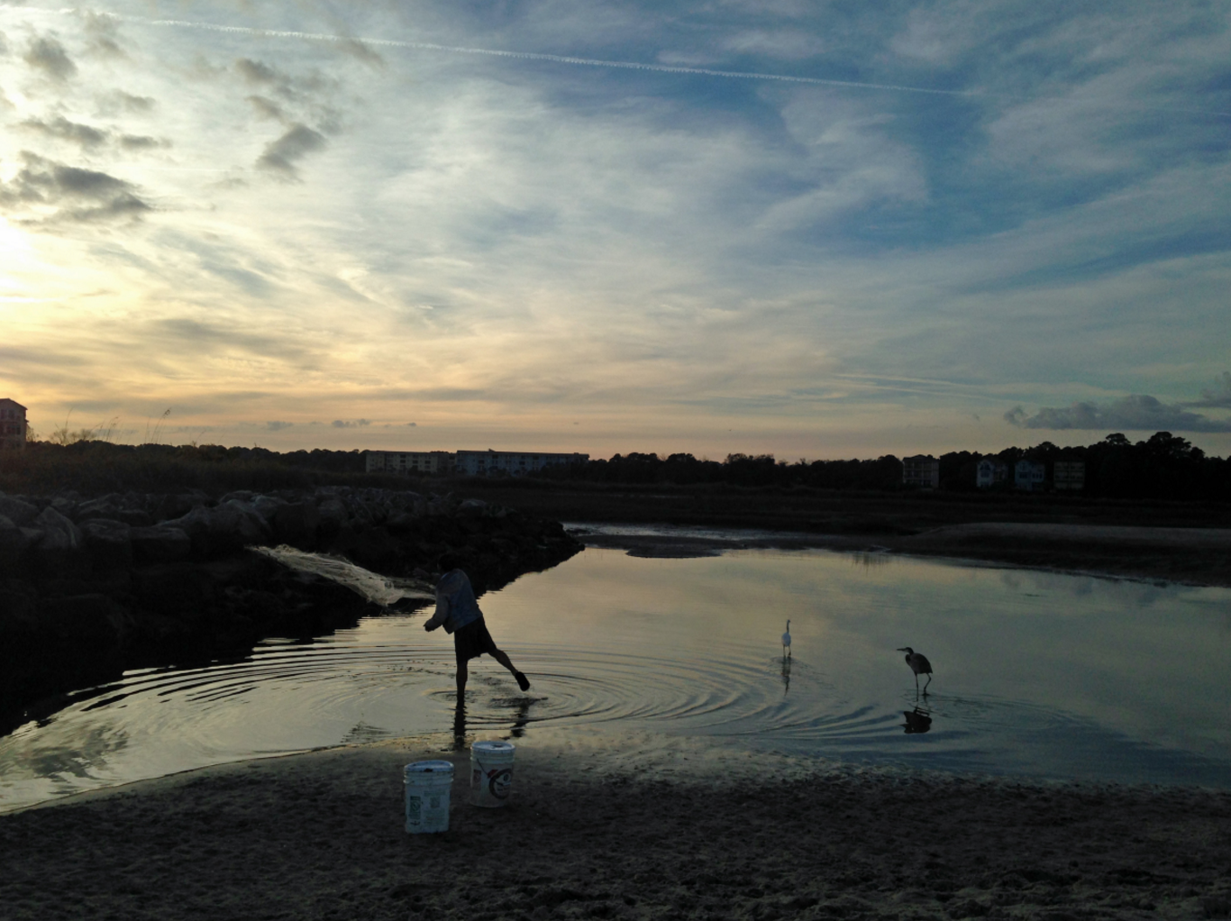 A fisherman throws a net into the fading sunset on Hilton Head Island, South Carolina. (Cheryl Welch | Travel Beat Magazine)